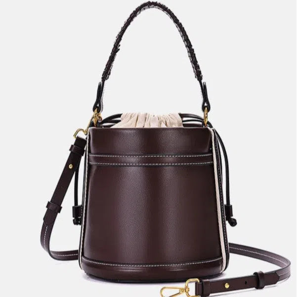 Brown PU leather bucket bag with woven texture, dual handles, and contrast stitching on a neutral background