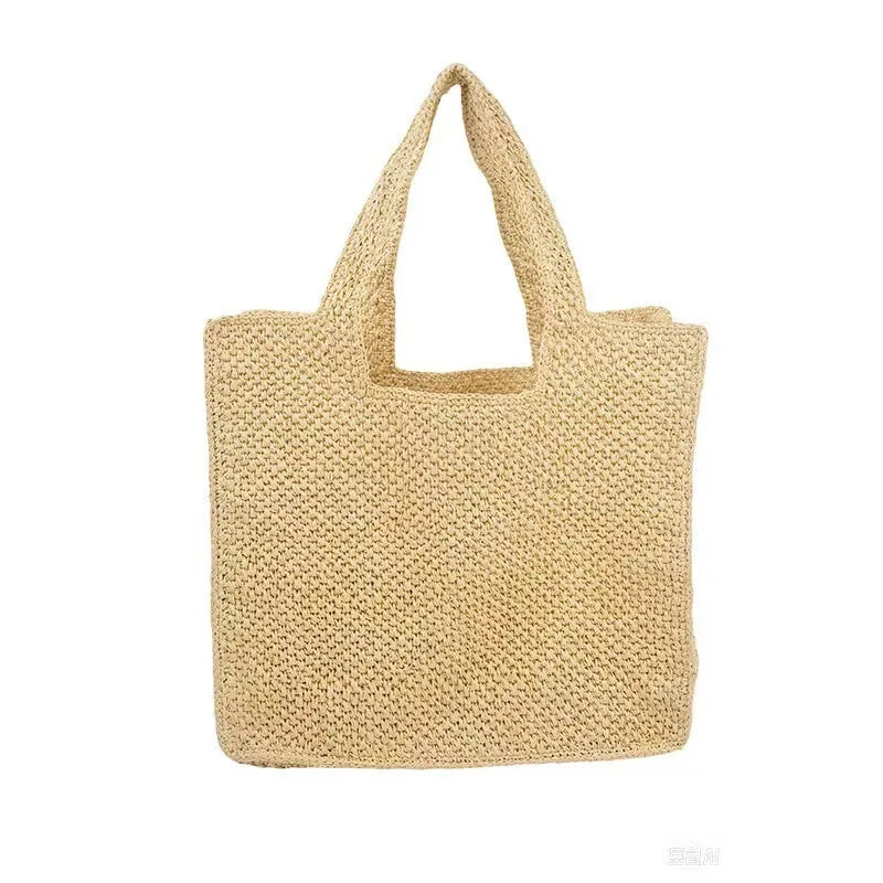 Straw woven bucket tote bag in khaki colour showing double shoulder straps and woven texture detail