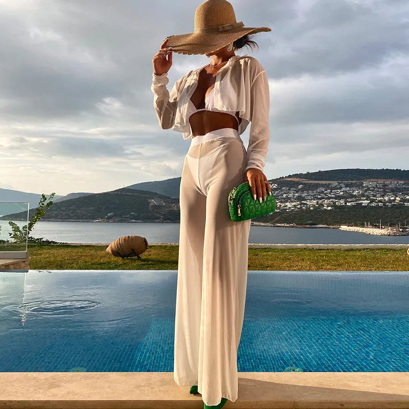 White women's four-piece swimsuit set showing backless top, high-waisted trousers, bra, and panties arranged together