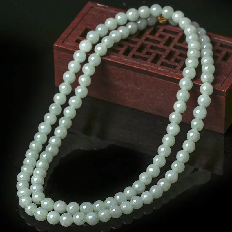 Adjustable natural jade bead necklace with 6.5mm round white and green beads on a long chain.