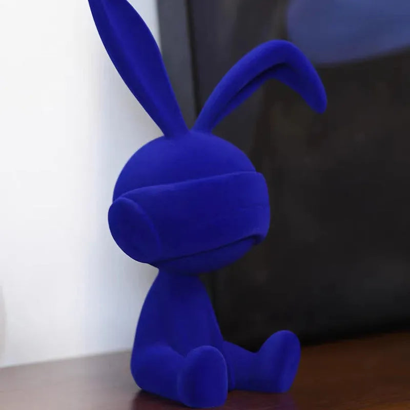 Suede blindfold rabbit resin table ornament in blue, green, or red colour.