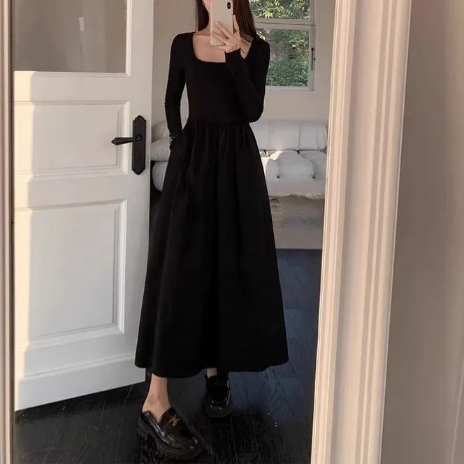 Women's black knitted dress with square collar, long sleeves, and an elastic A-line skirt.