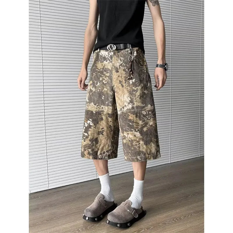 Yellow jeans with a snake camouflage pattern, shown in a cropped length.