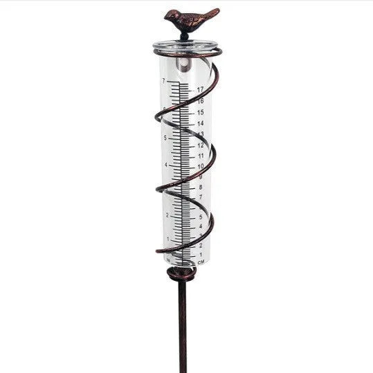 Cast iron outdoor garden rain gauge with hummingbird decoration and measurement scale.