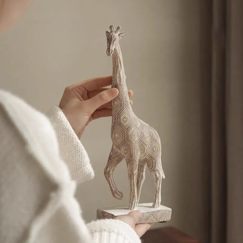 Wood colour synthetic resin giraffe decorative ornament on a shelf.
