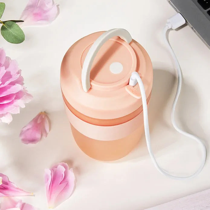 Portable purple blender cup with four stainless steel blades and a USB charging cable
