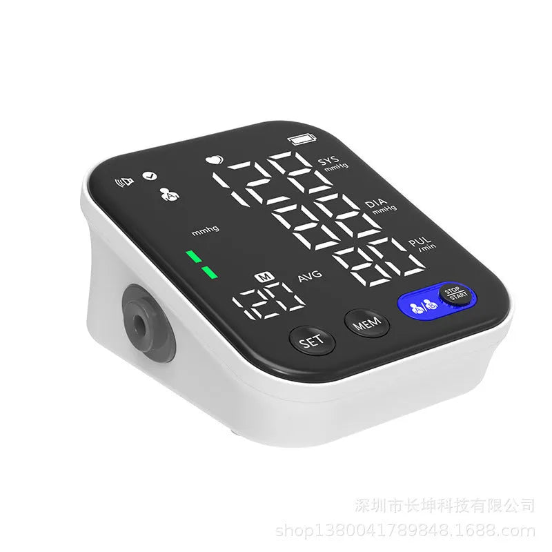 White electronic blood pressure monitor with large LCD screen and attached upper arm cuff
