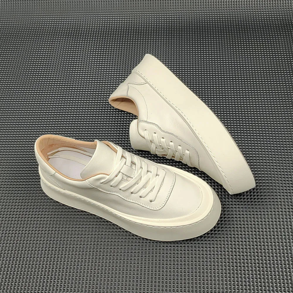 Boys black cowhide leather platform board shoes with a thick rubber sole and white stitching.
