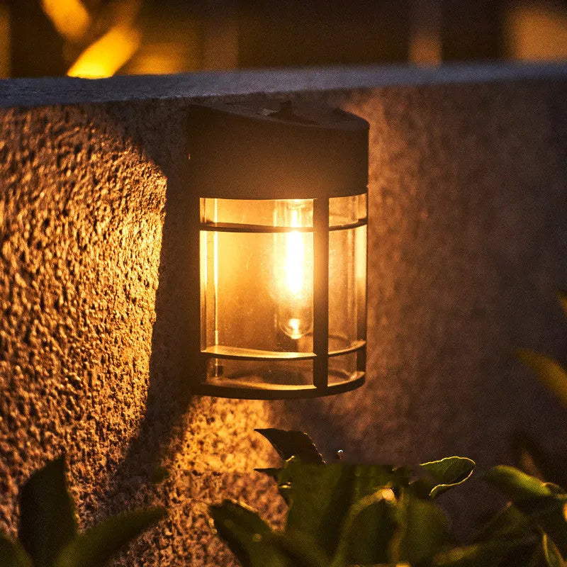 Set of 6 solar-powered outdoor wall lights with warm white illumination mounted on a garden wall