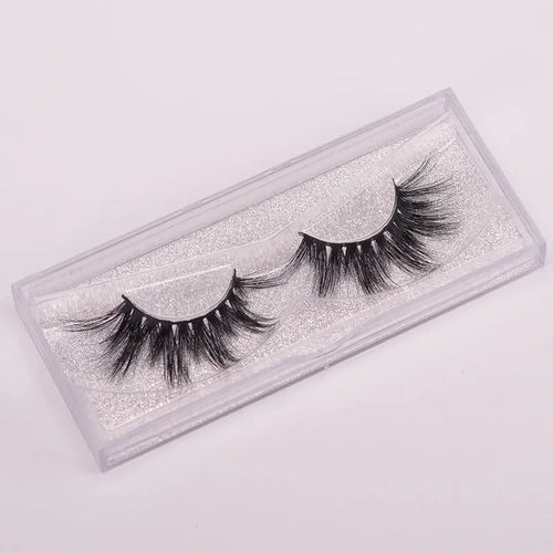 Hand-made 5D mink false eyelashes set with protective cap and dual-ended brush on a clean background