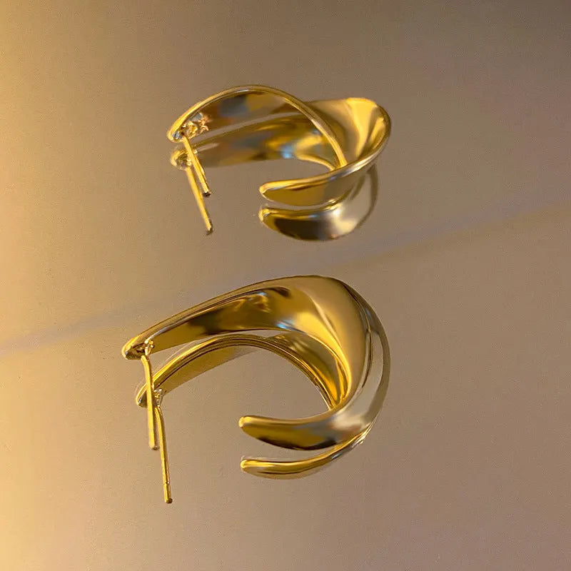 Twisted geometric metal earrings with circular design in gold or silver electroplated finish