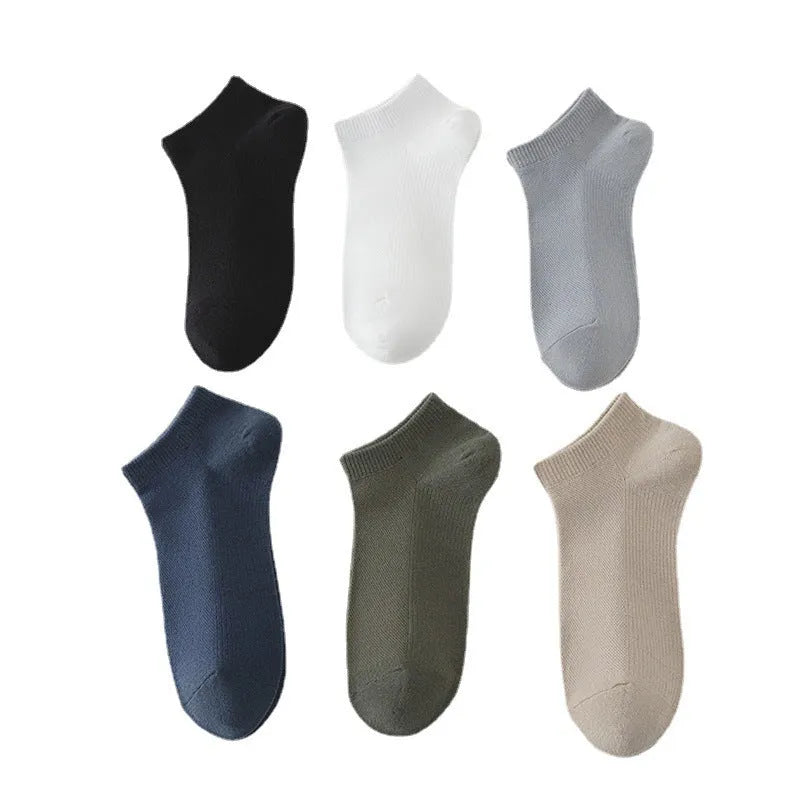 Men's solid colour low-cut polyester boat socks in assorted hues on a white background.