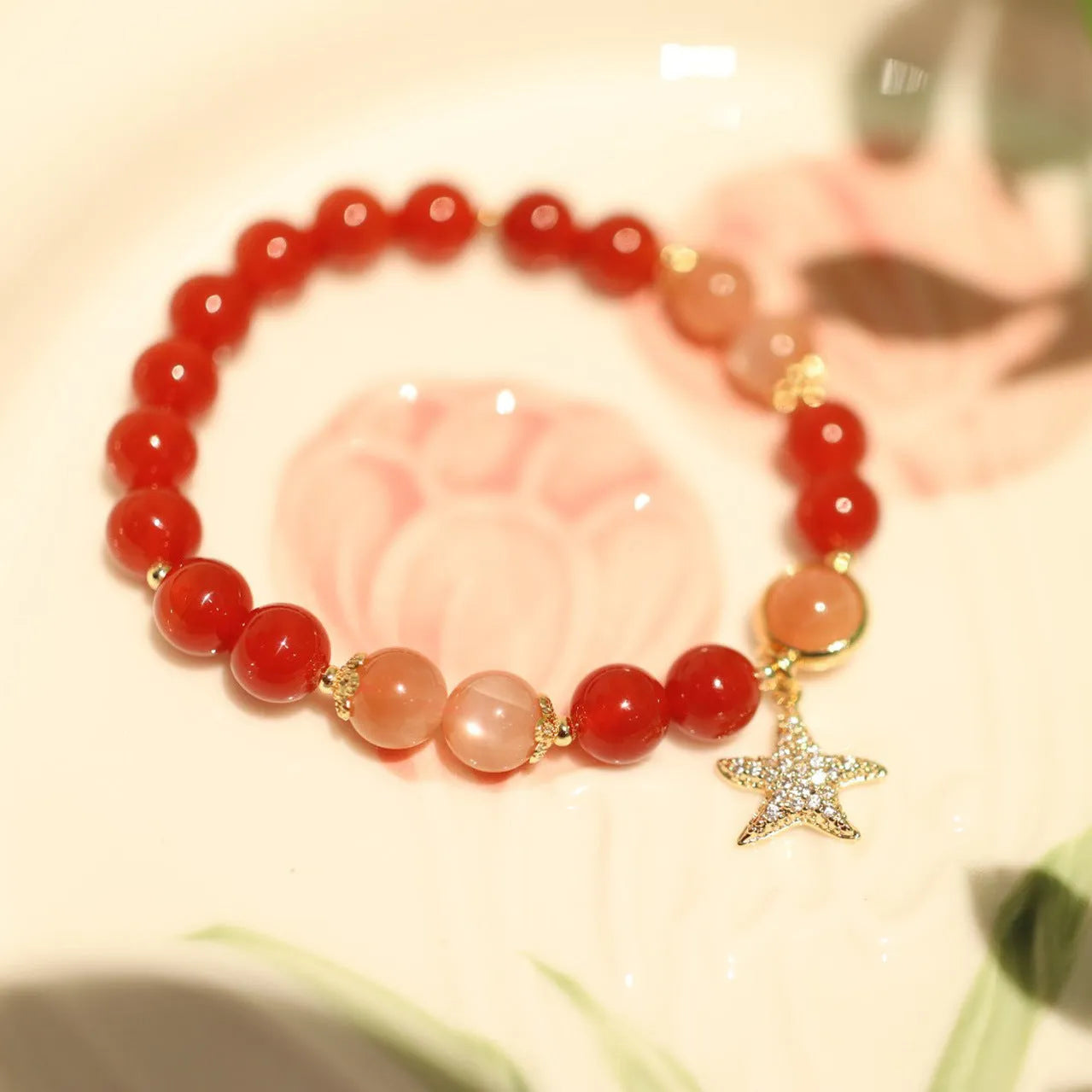 Handmade women's bracelet with 8mm red agate and orange sunstone beads, featuring star and cloud designs.