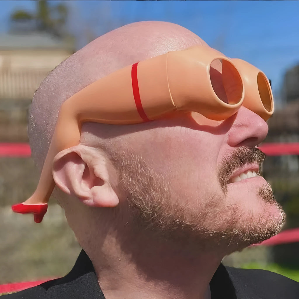 Orange novelty sunglasses with sculpted plastic leg attachments wrapped around head model.