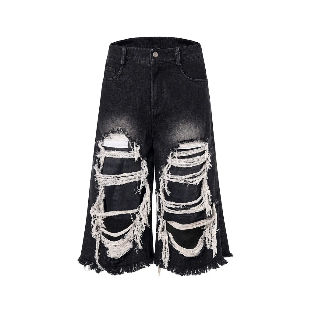 Black women's cropped wide-leg jeans with a mid-high waist and ripped patch details on a loose fit.