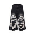 Black women's cropped wide-leg jeans with a mid-high waist and ripped patch details on a loose fit.
