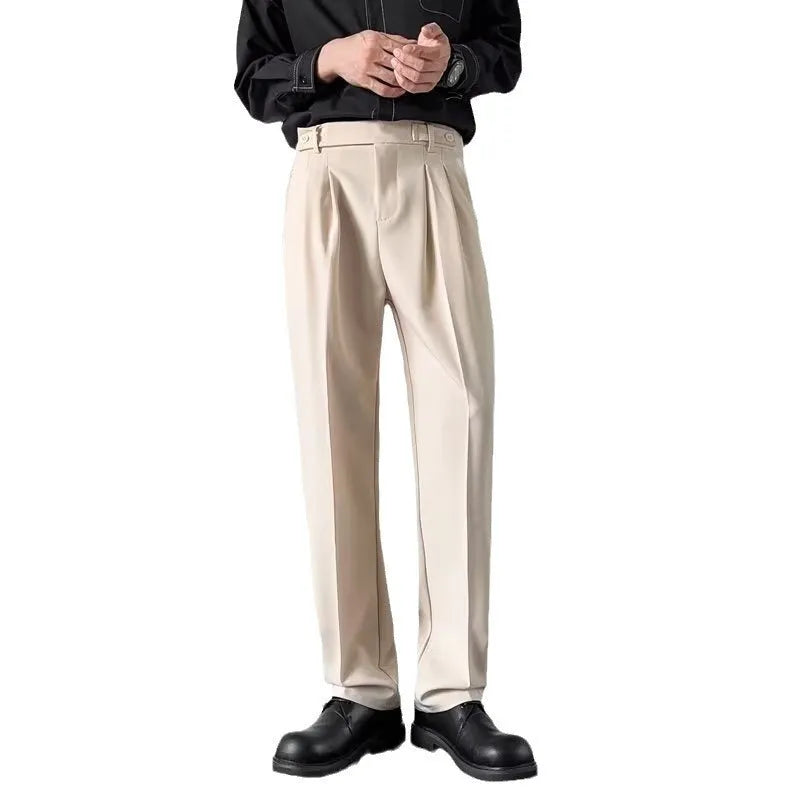 Men's straight leg loose fit suit trousers in apricot colour hanging on a hanger.