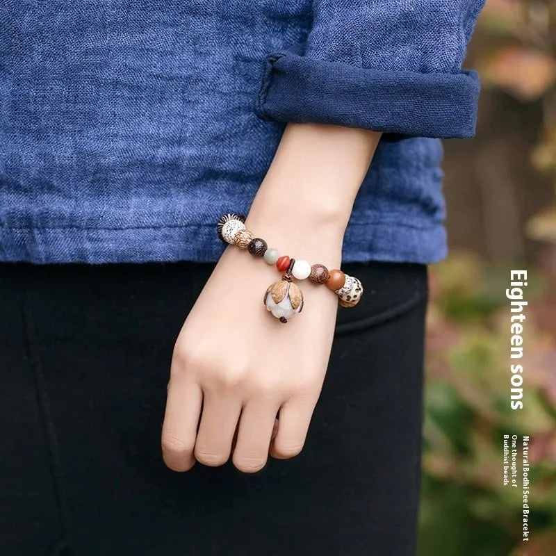 Handmade brown Bodhi seed bead bracelet with geometric design on a 16cm wrist.