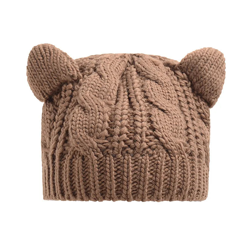 Hand made red knitted winter beanie with 3D cat ears on a mannequin head.