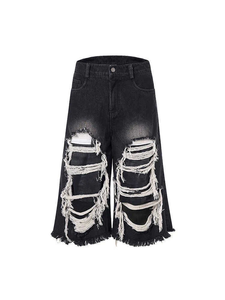 Black women's cropped wide-leg jeans with a mid-high waist and ripped patch details on a loose fit.