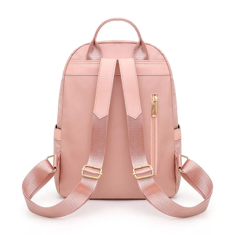 Black casual nylon backpack with shoulder straps, showing internal organiSation pockets and a soft handle.