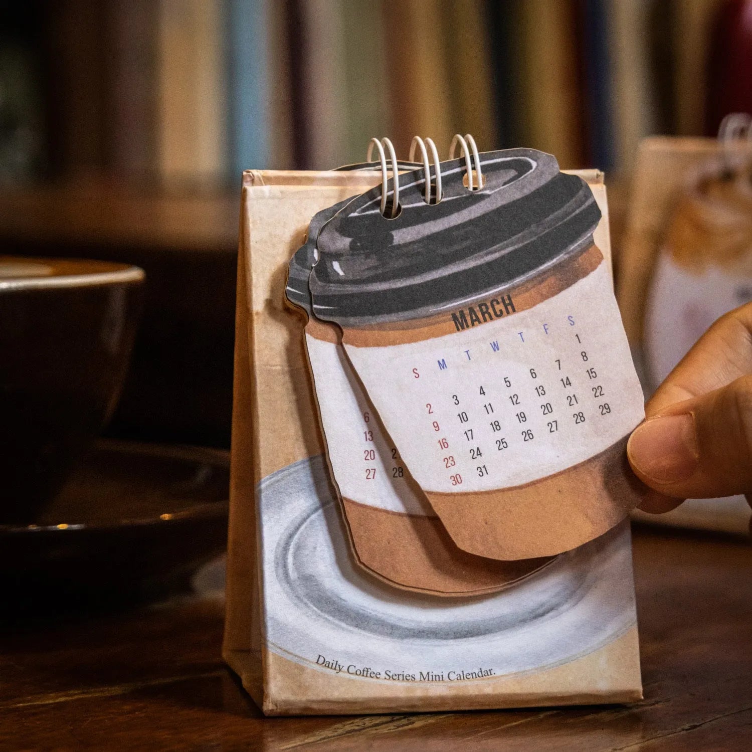 Four mini paper desk calendars for 2025 with different motivational themes in simple modern design