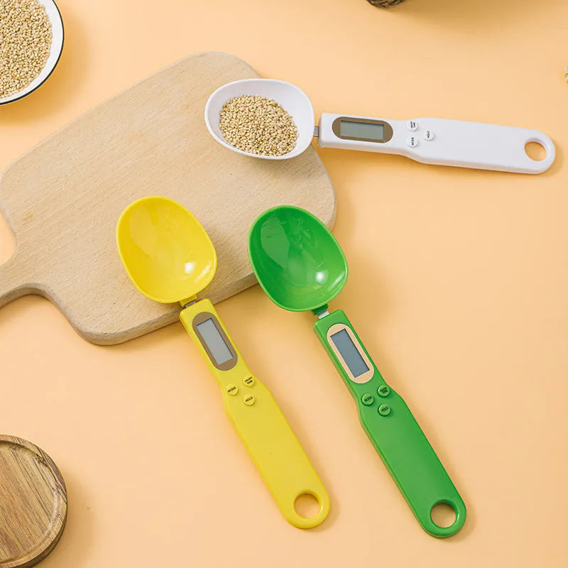 White digital kitchen spoon scale with LCD display showing weight measurement