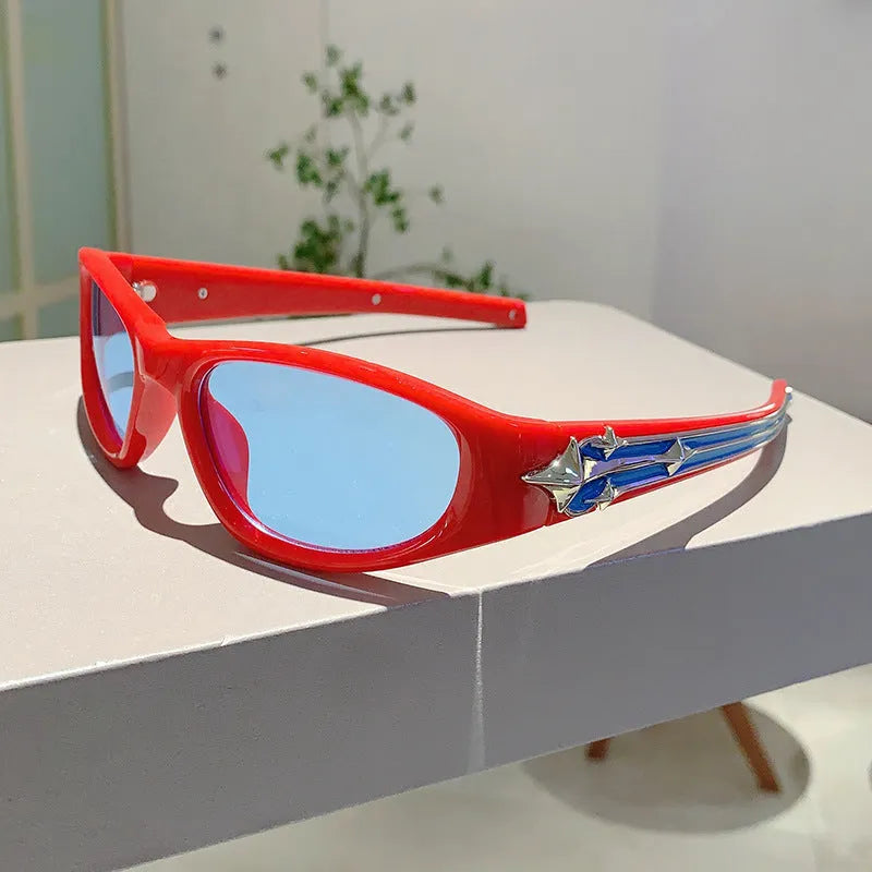 Black frame sports sunglasses with blue polycarbonate lenses on a wooden surface.