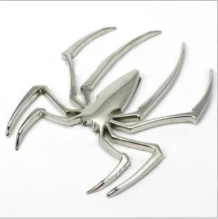 Three-dimensional metallic spider sticker in gold, silver, black, and red colours