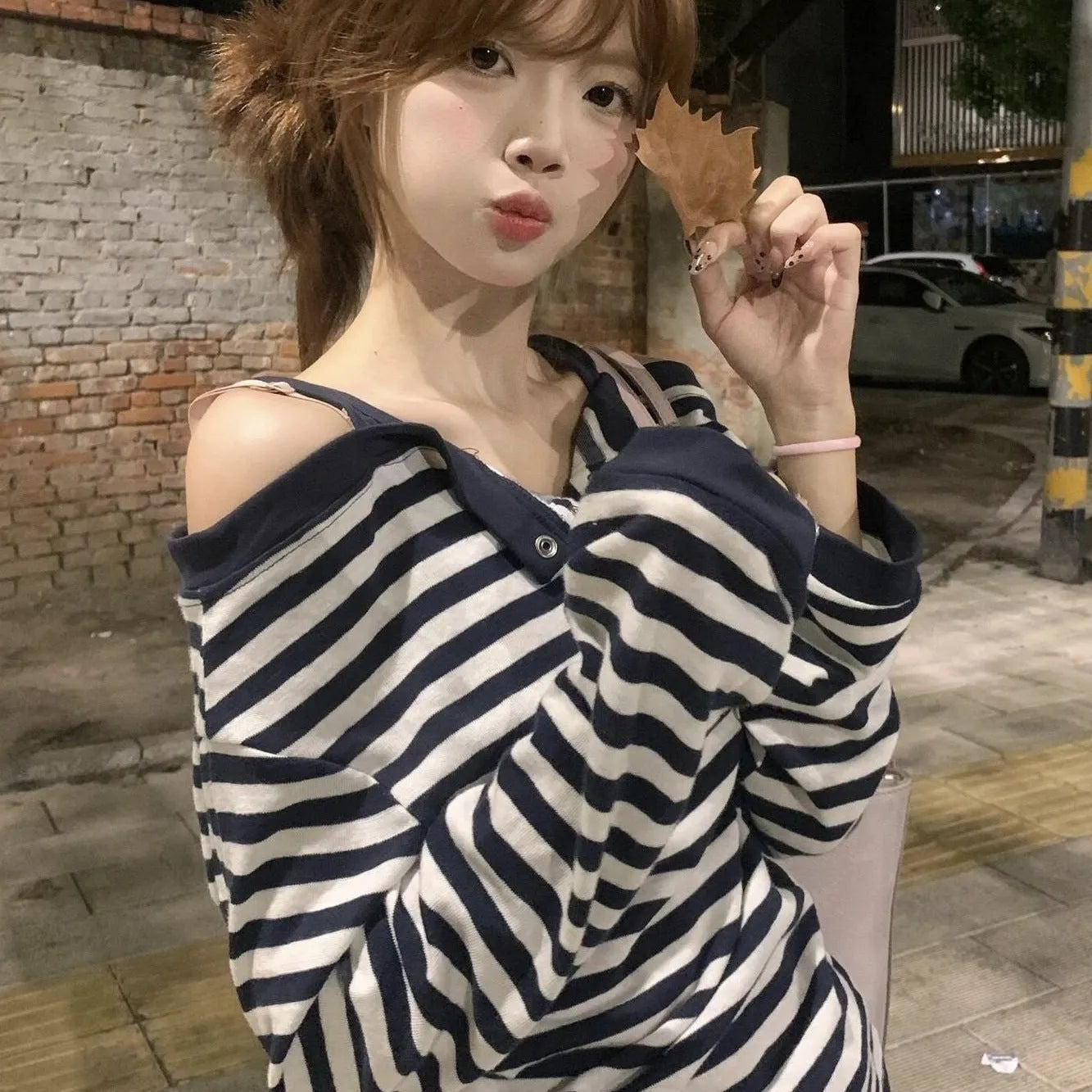 Dark blue women's oversized long-sleeved T-shirt with embroidery and stripes, laid flat.