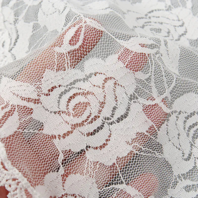 Round wedding veil head covering with floral decoration in black or white colours measuring 30cm diameter