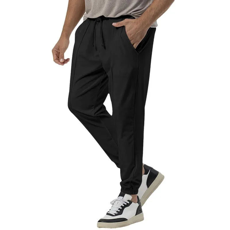 Men's grey straight-leg casual sweatpants with an elasticated waistband on a neutral background.