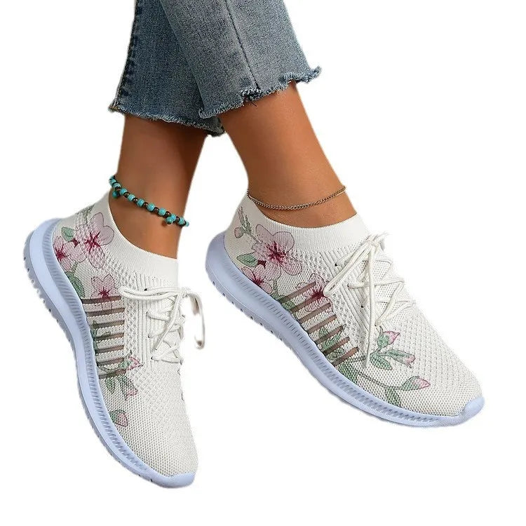 Women's Milky White mesh Flyknit running shoes with a round toe and flat rubber sole.
