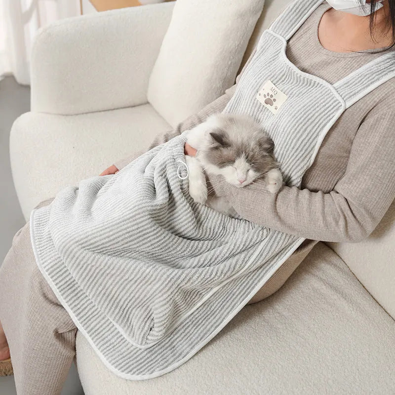 Cloth cat petting apron in a striped pattern, shown worn by a person holding a cat.