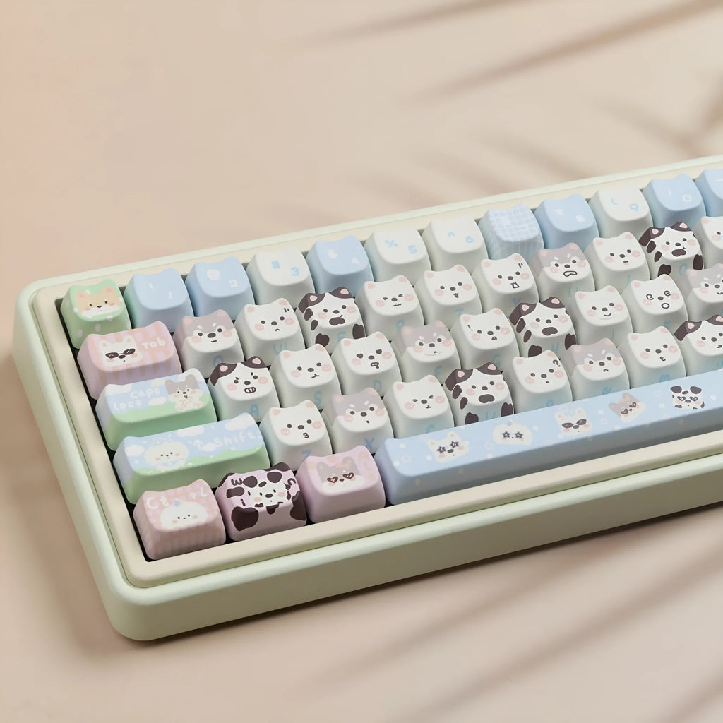 Colourful PBT key cap set for mechanical keyboards with printed cat and puppy designs.