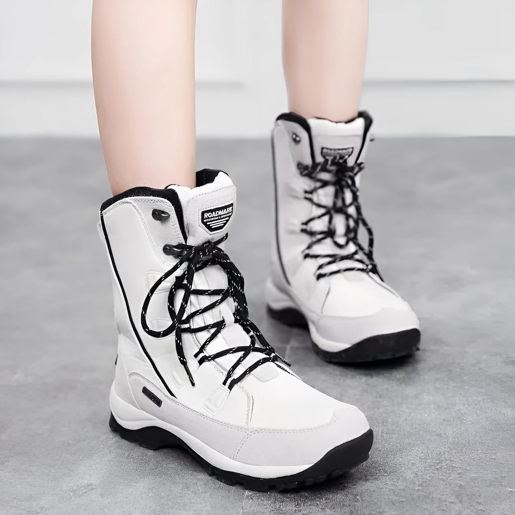 Women's black genuine leather mid-calf snow boots with a rubber sole on a white background.