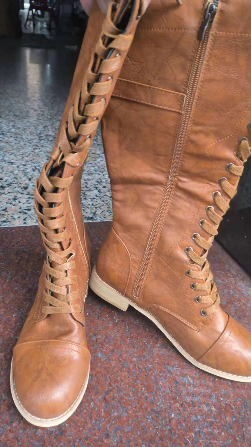 Women's black knight boots with cross strap design on artificial PU upper