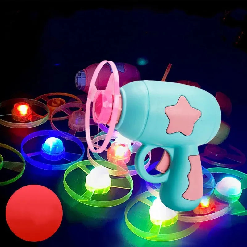Blue and yellow LED light-up flying saucer launcher toy set with plastic gun and three discs.