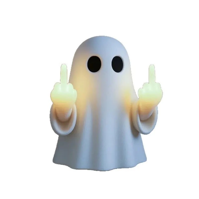 White plastic ghost statue night lamp for Halloween decoration on a dark surface.