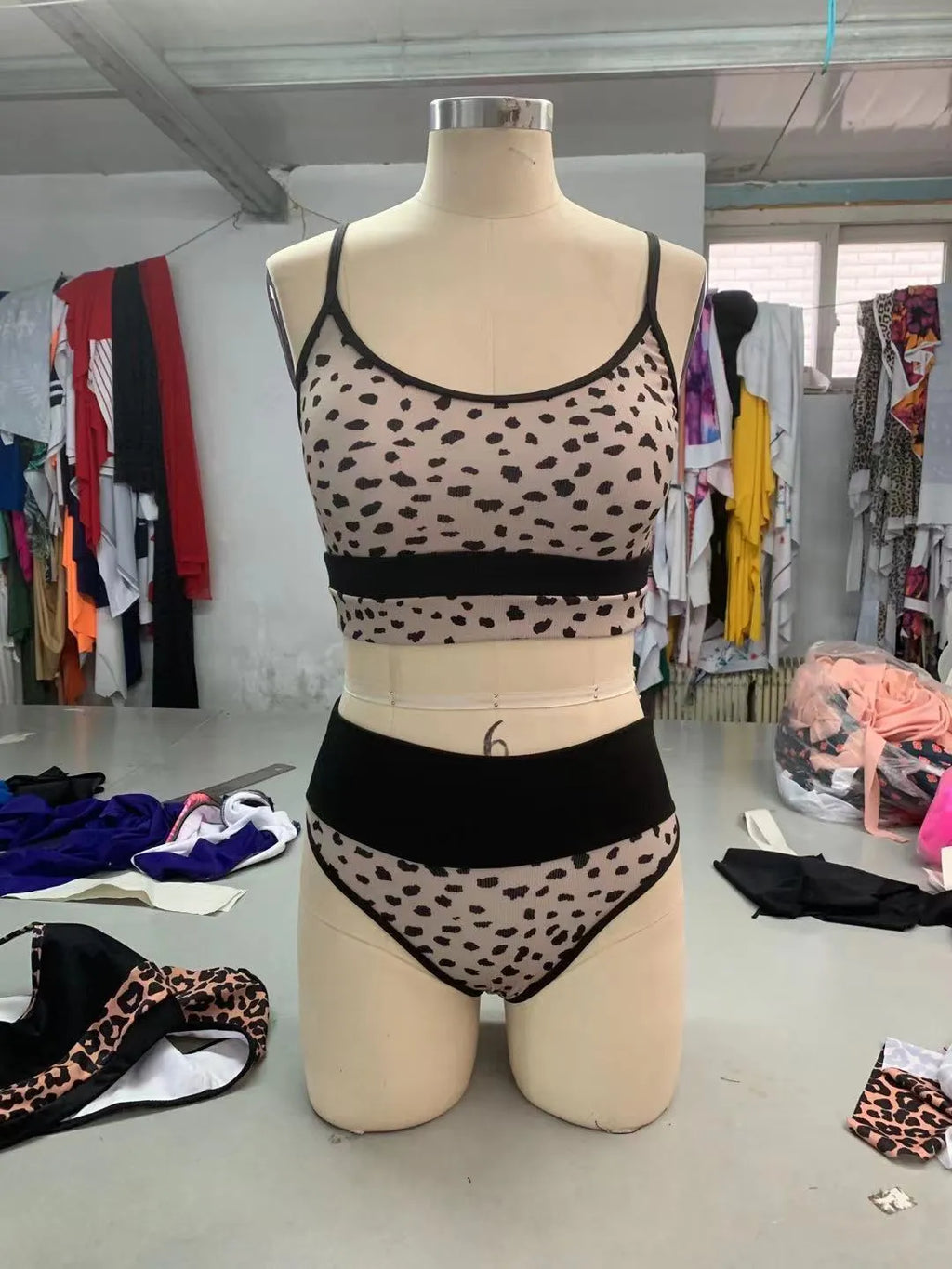Women's white and leopard print high waist bikini swimsuit set on a mannequin.
