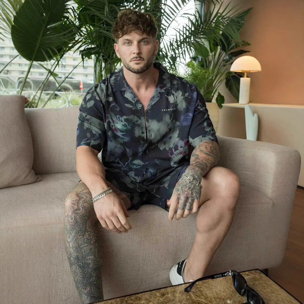 Man's loose-fitting printed short sleeve top in a light colour, showing cardigan style and floral pattern detail.