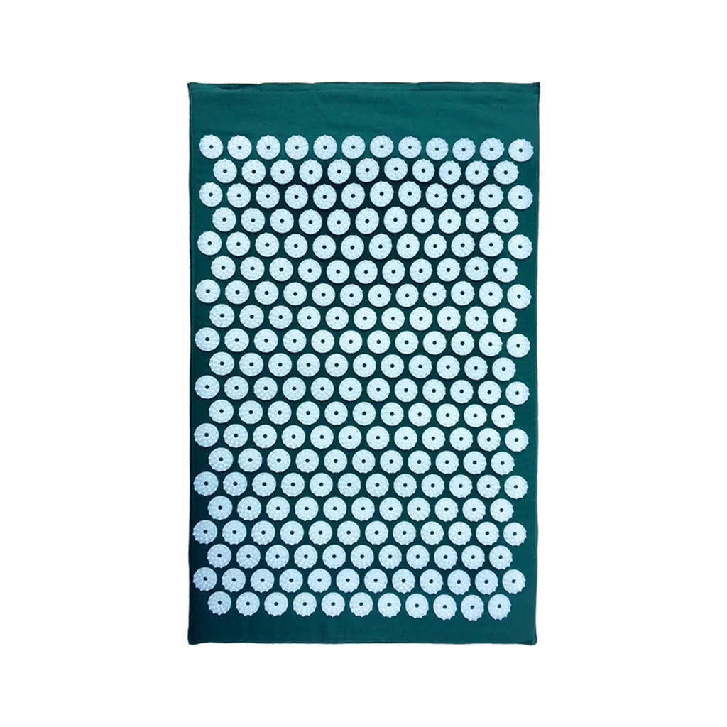 Black and blue acupuncture massage mat with cushion and headrest on floor