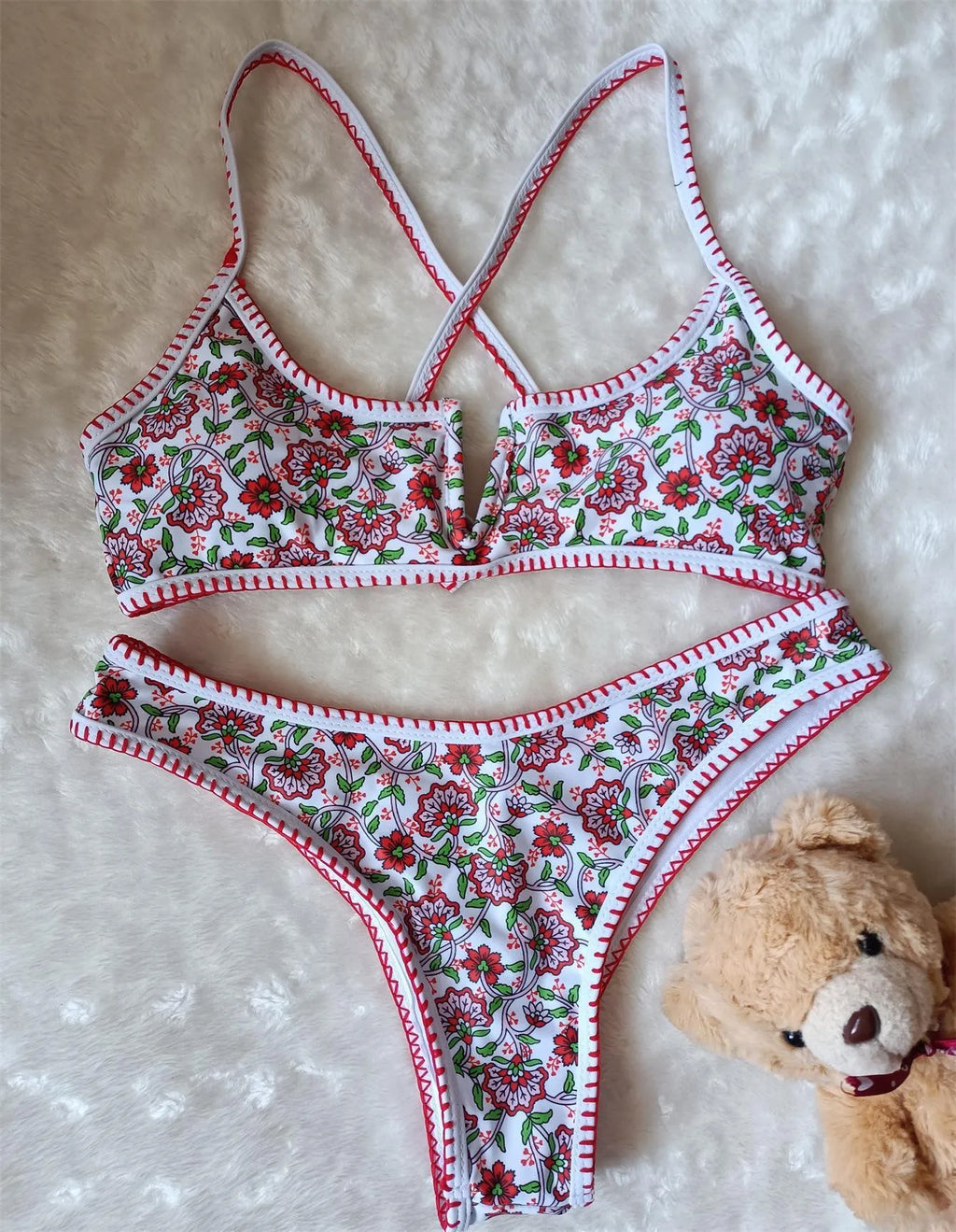 Women's V-neck swimsuit with embroidered detail and floral printed pattern in briefs style