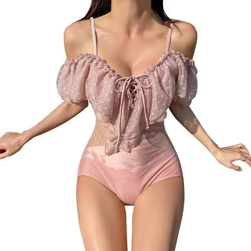 Solid pink women's one-piece nylon swimsuit on a hanger, showing front design.