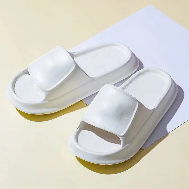 Pair of thick-soled white EVA flip-flop slippers with a non-slip patterned sole.