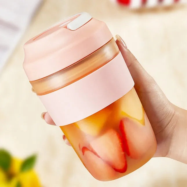 Portable purple blender cup with four stainless steel blades and a USB charging cable
