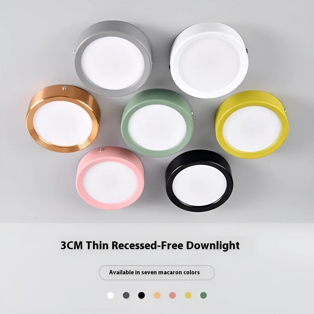 Ultra-thin surface mounted LED downlight in a choice of seven shell colours including black, white, gold, and pink.