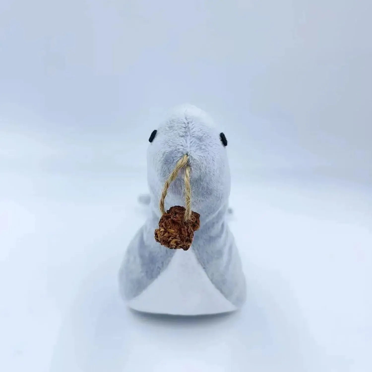Blue sea lion plush cat toy with detailed stitching, shown alongside catnip filling and bell component