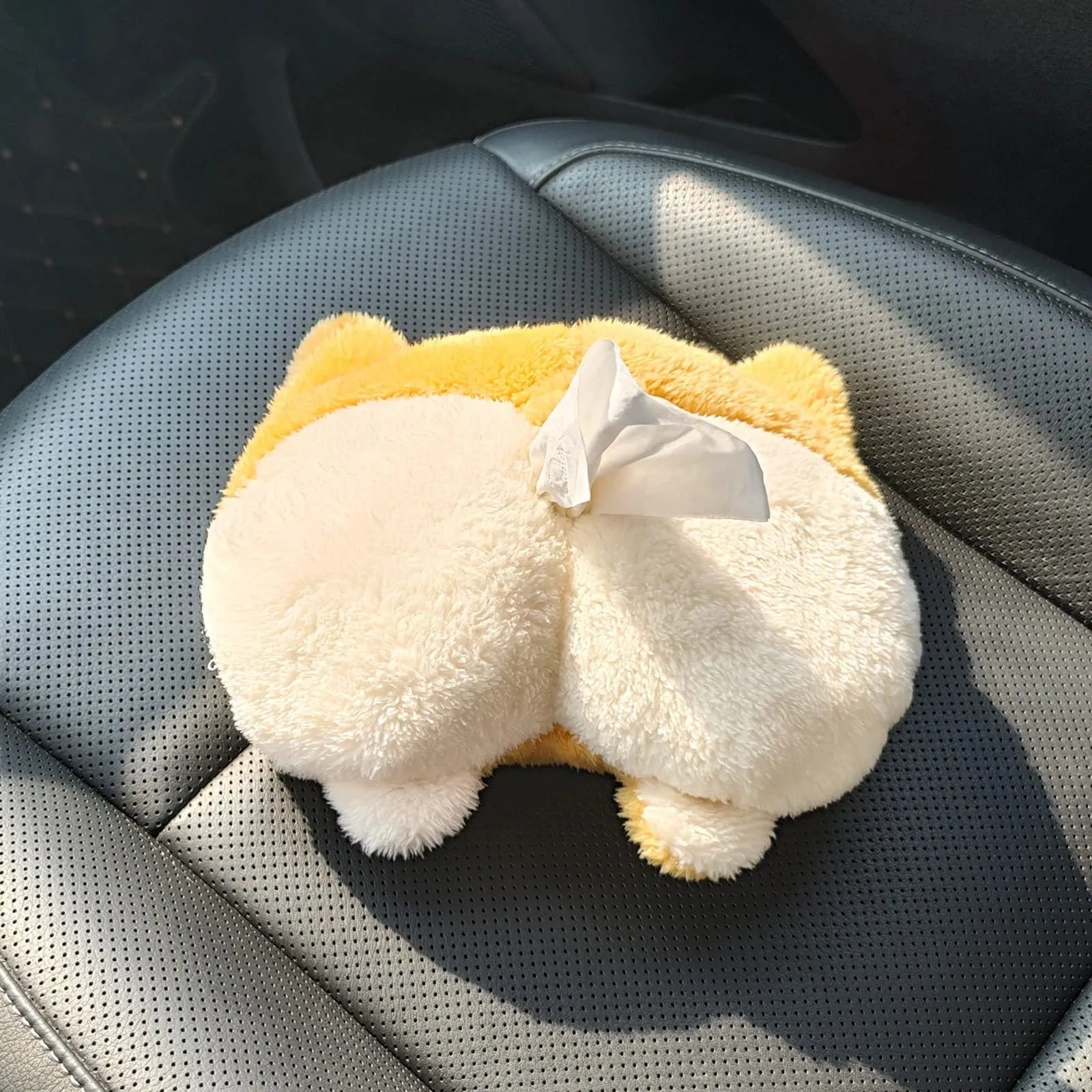 Yellow corgi butt shaped car tissue box cover with elastic strap for sun visor mounting.