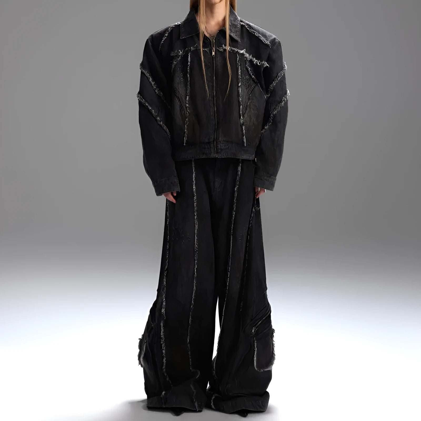 Distressed black gradient denim coat with padded shoulders and matching trousers laid flat